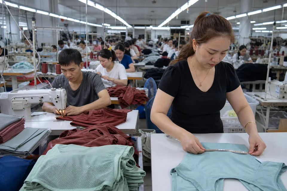 Sewing lines and a quality inspector at a garment factory in Vietnam
